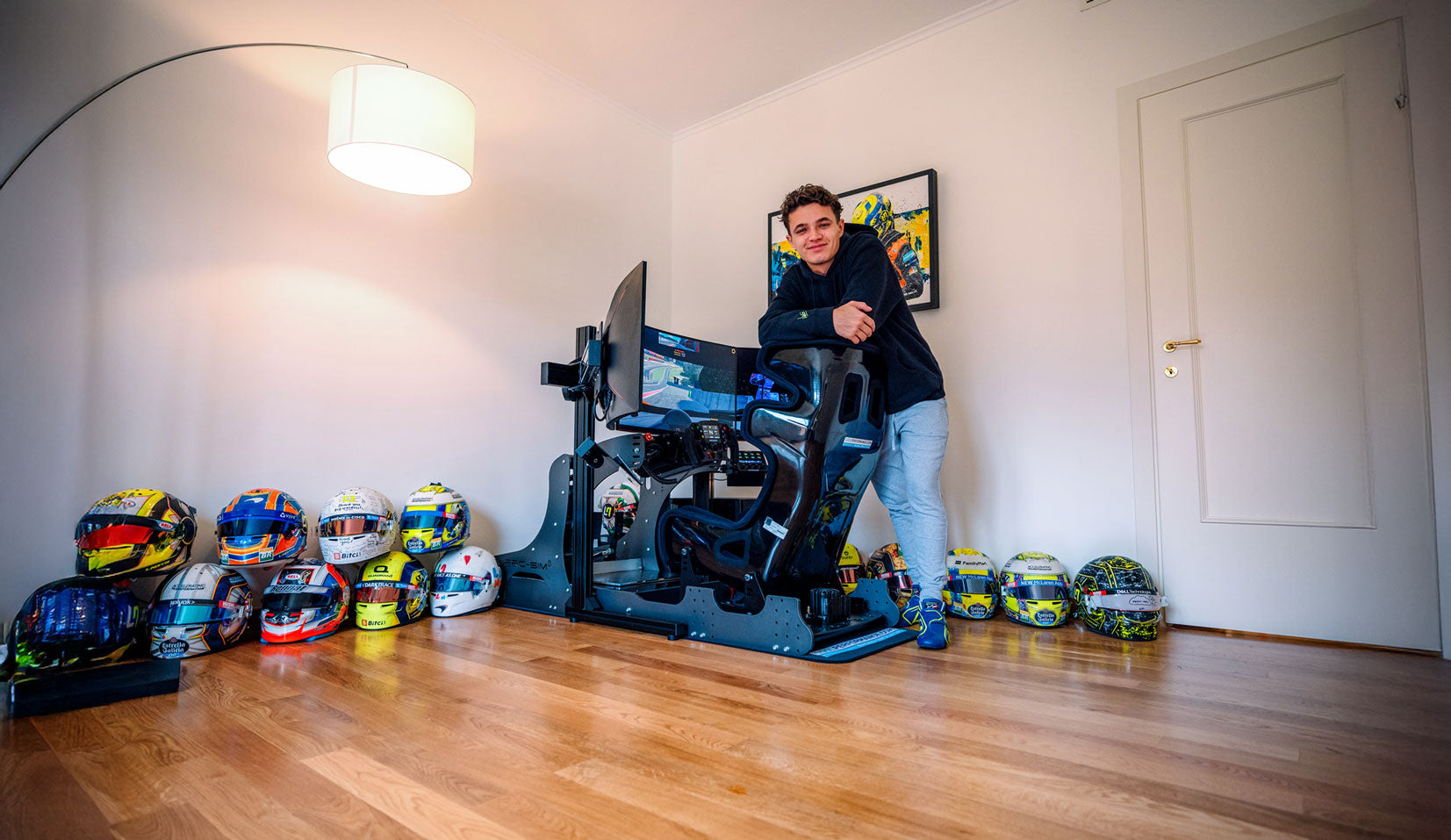 lando norris stood beside his gt pro racing simulator at his home in monaco