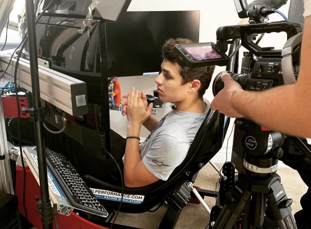 Lando Norris being filmed in a Cool Performance Formula Pro simulator