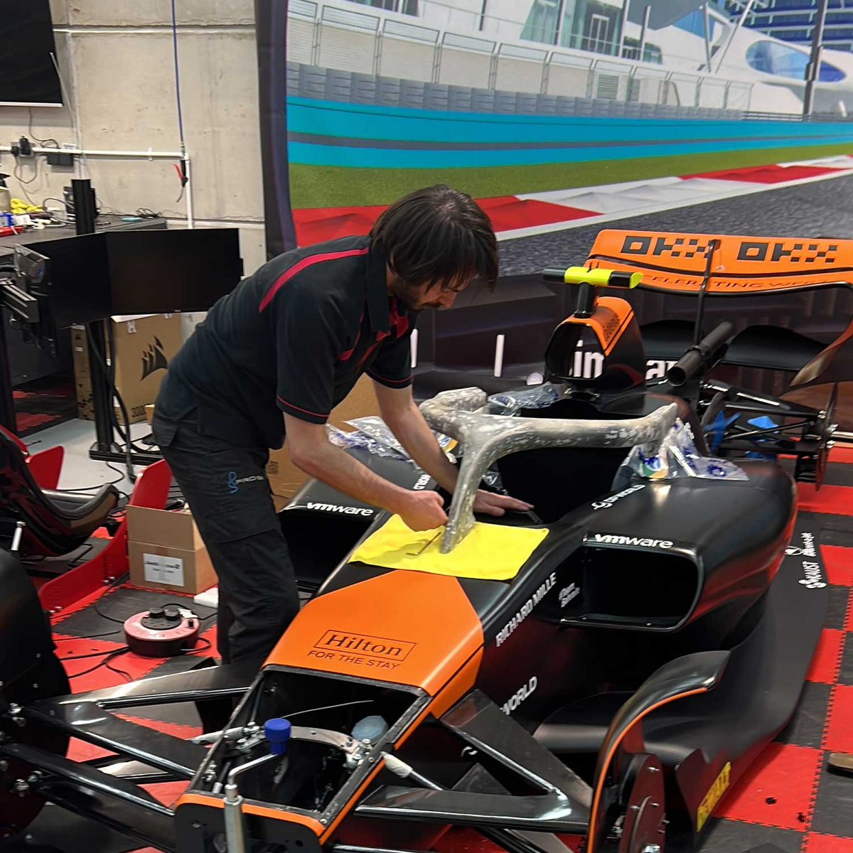 Adrian Quaife-Hobbs working on a Cool Performance F1 simulator