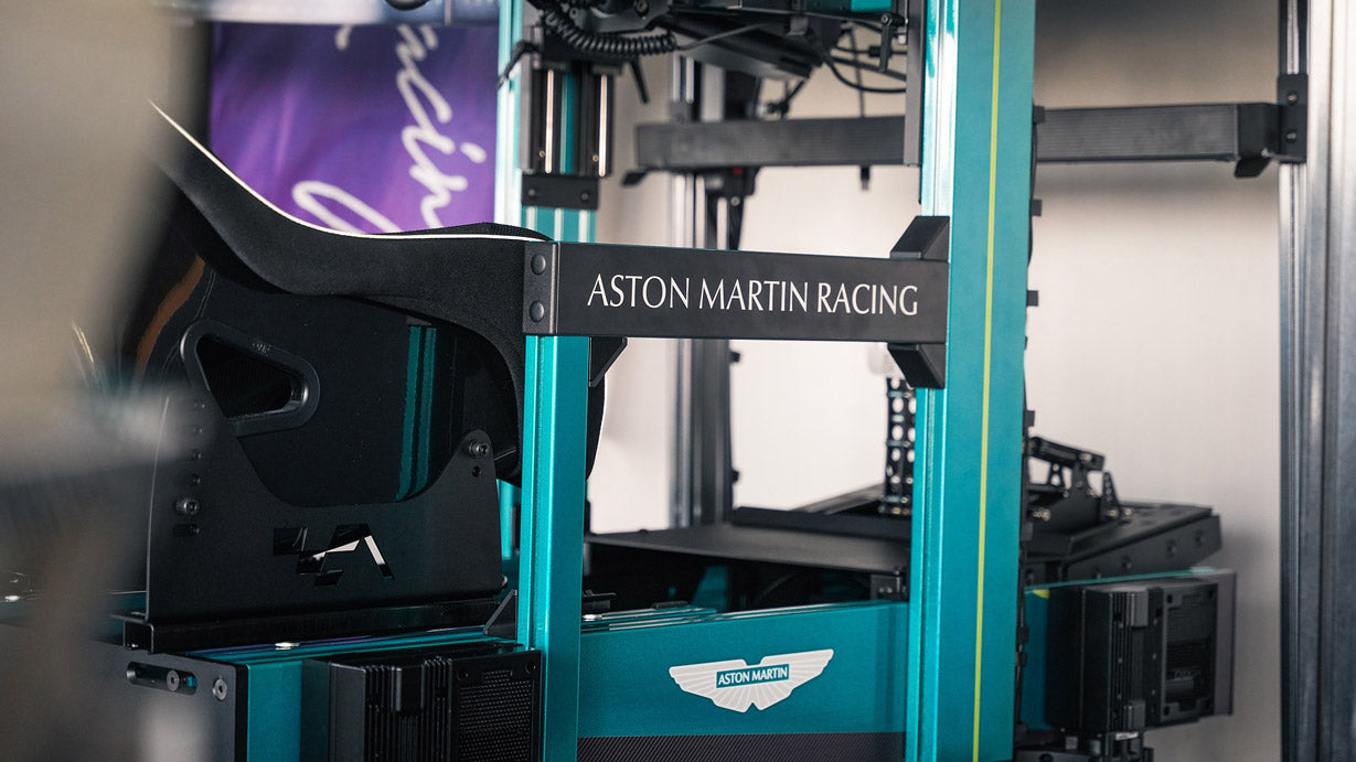 Custom branded racing simulator for Aston Martin, logo displayed on frame and custom blue colour