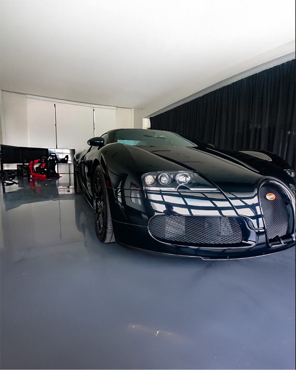 Cool Performance Formula racing simulator next to a Bugatti hypercar