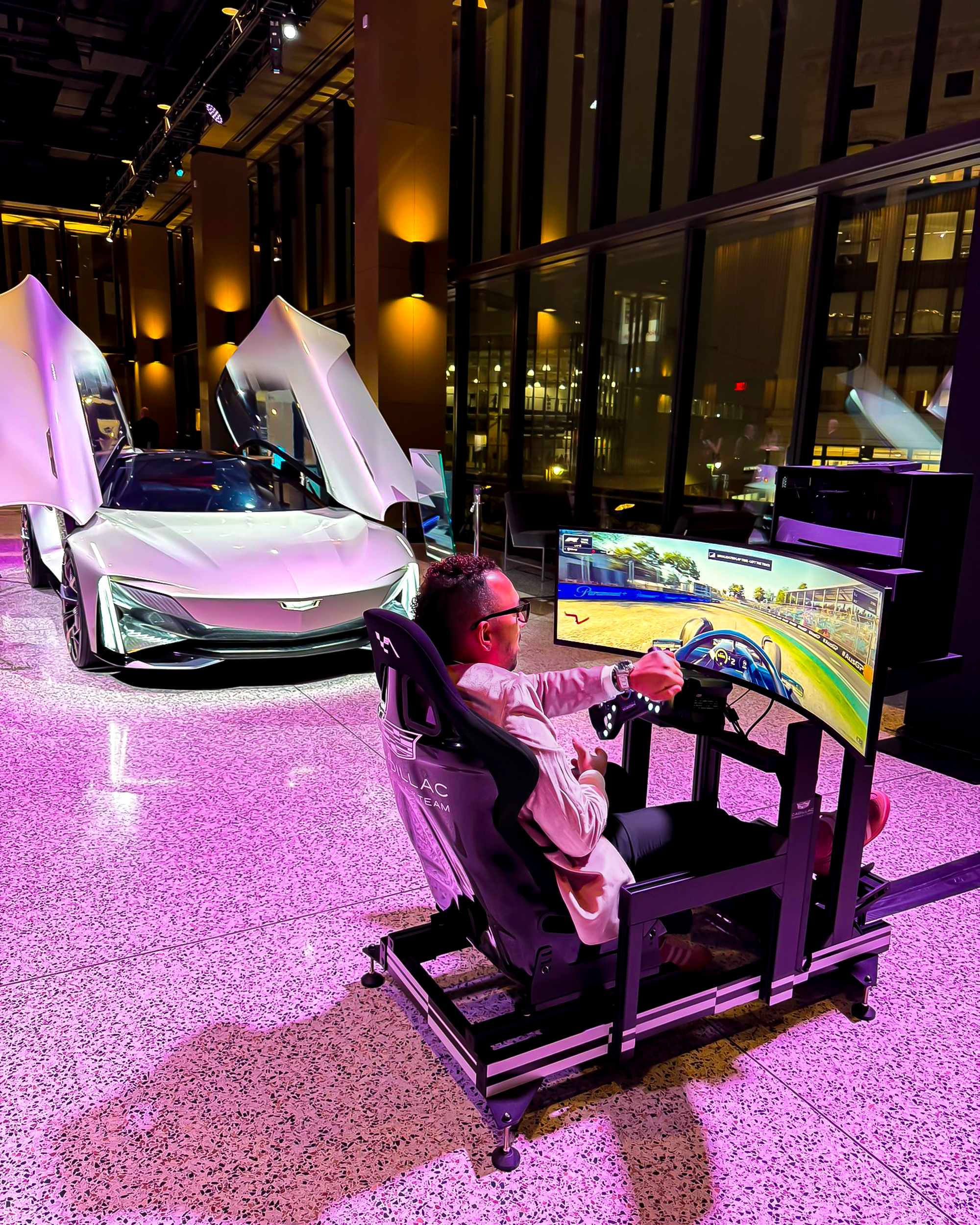 Cool Performance racing simulator rental with Cadilac prototype in background