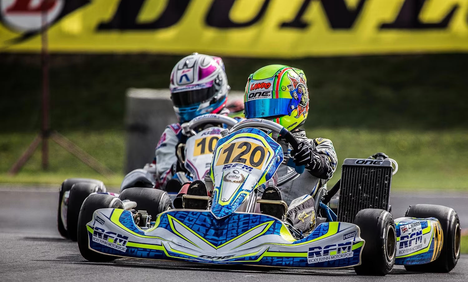 Two go kart drivers battling it out on track