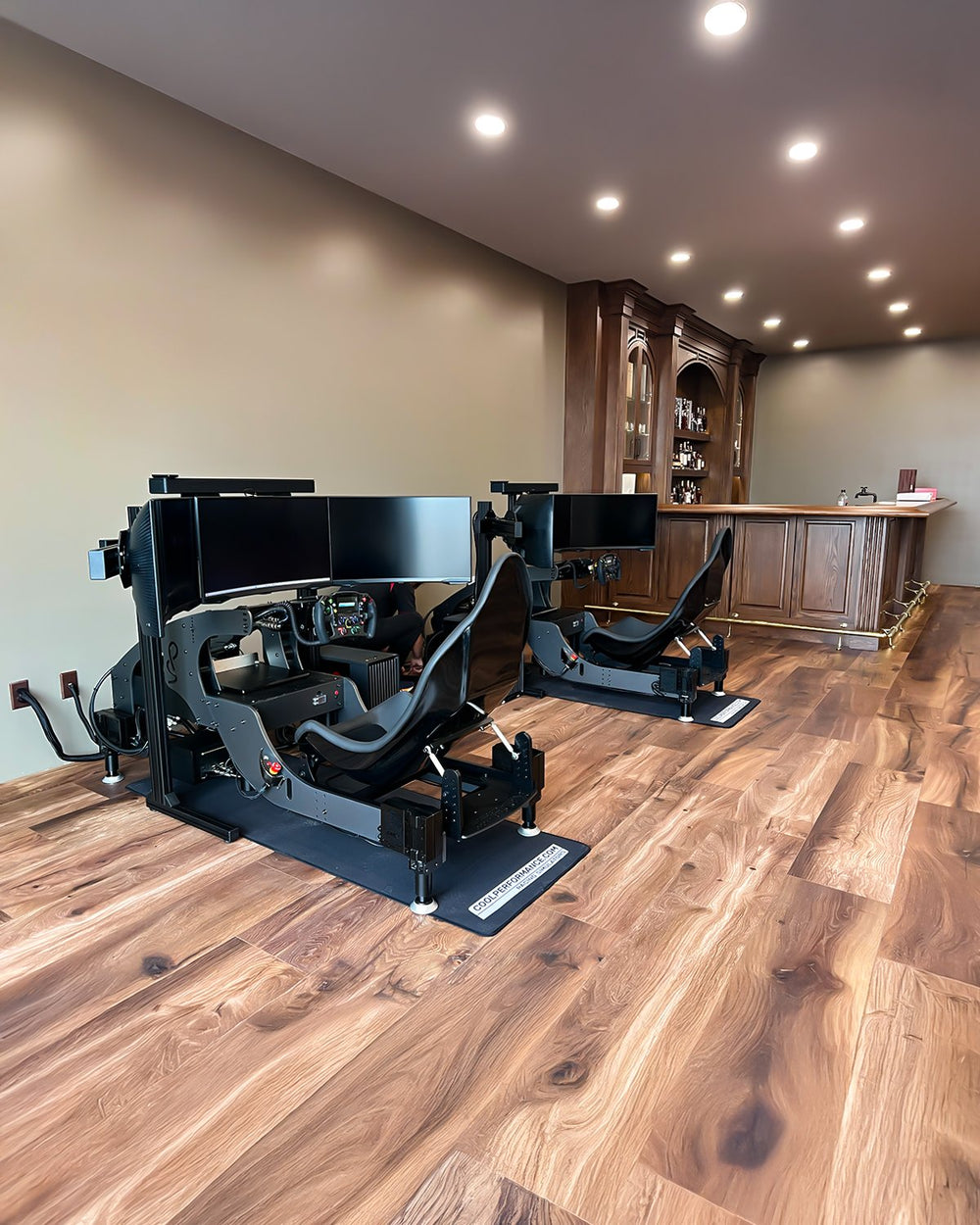Two black Formula Pro simulators with triple 32 inch curved monitors in a private bar, Arizona, USA