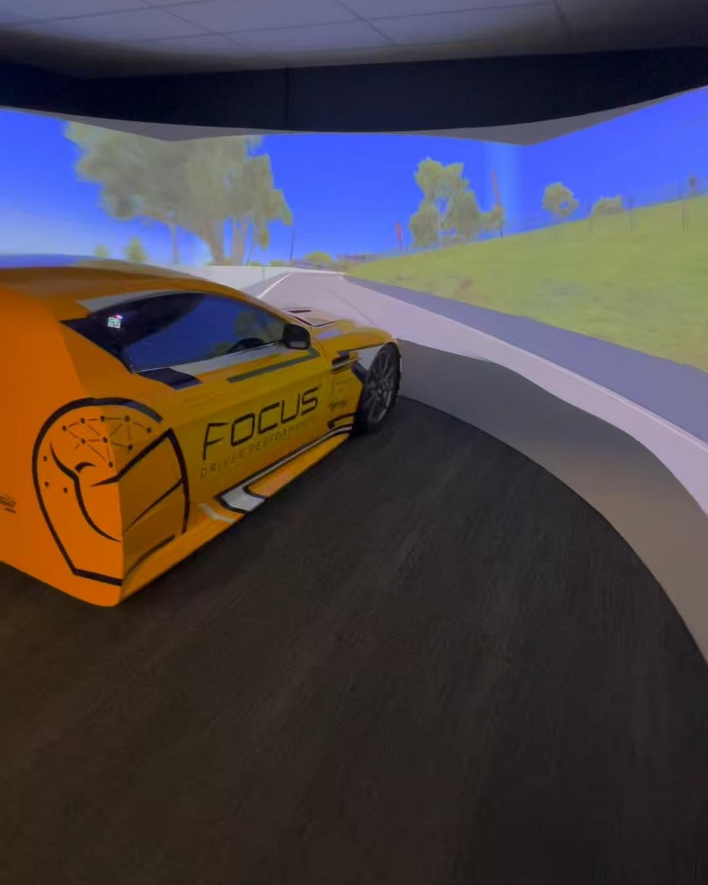 Aston Martin half cab simulator with projected wraparound screen at Focus Driver Performance, Australia