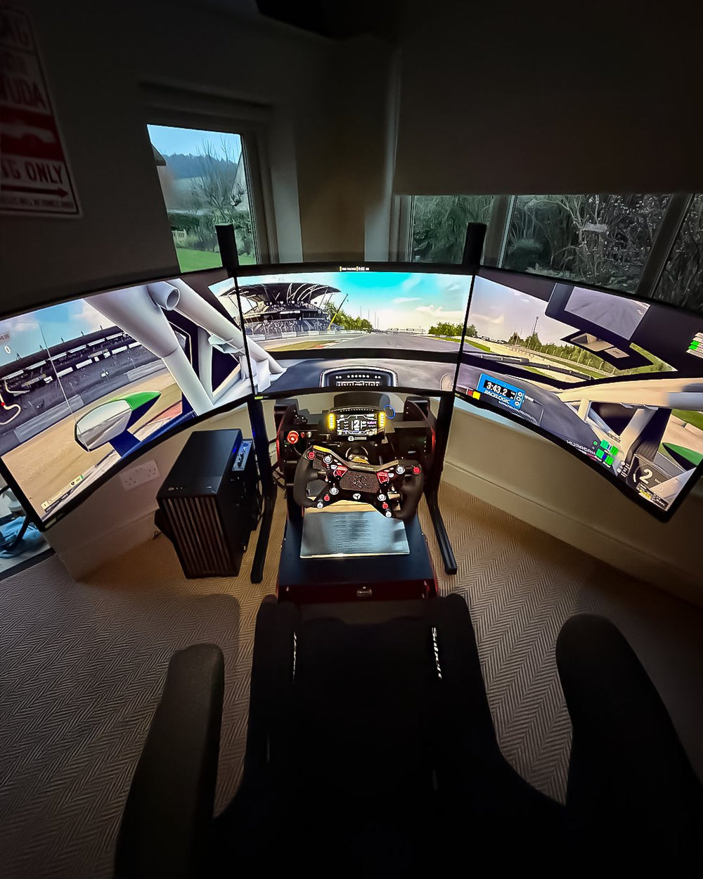 Red GT Pro with Samsung triple curved monitor in a bright home sim room