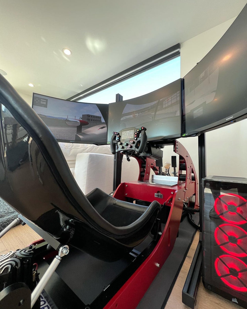 Red and black Formula simulator in an open living space, Los Angeles, California, USA