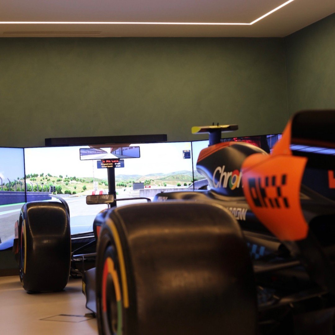 Full size 2024 F1 car simulator in McLaren livery with wraparound screens in a home