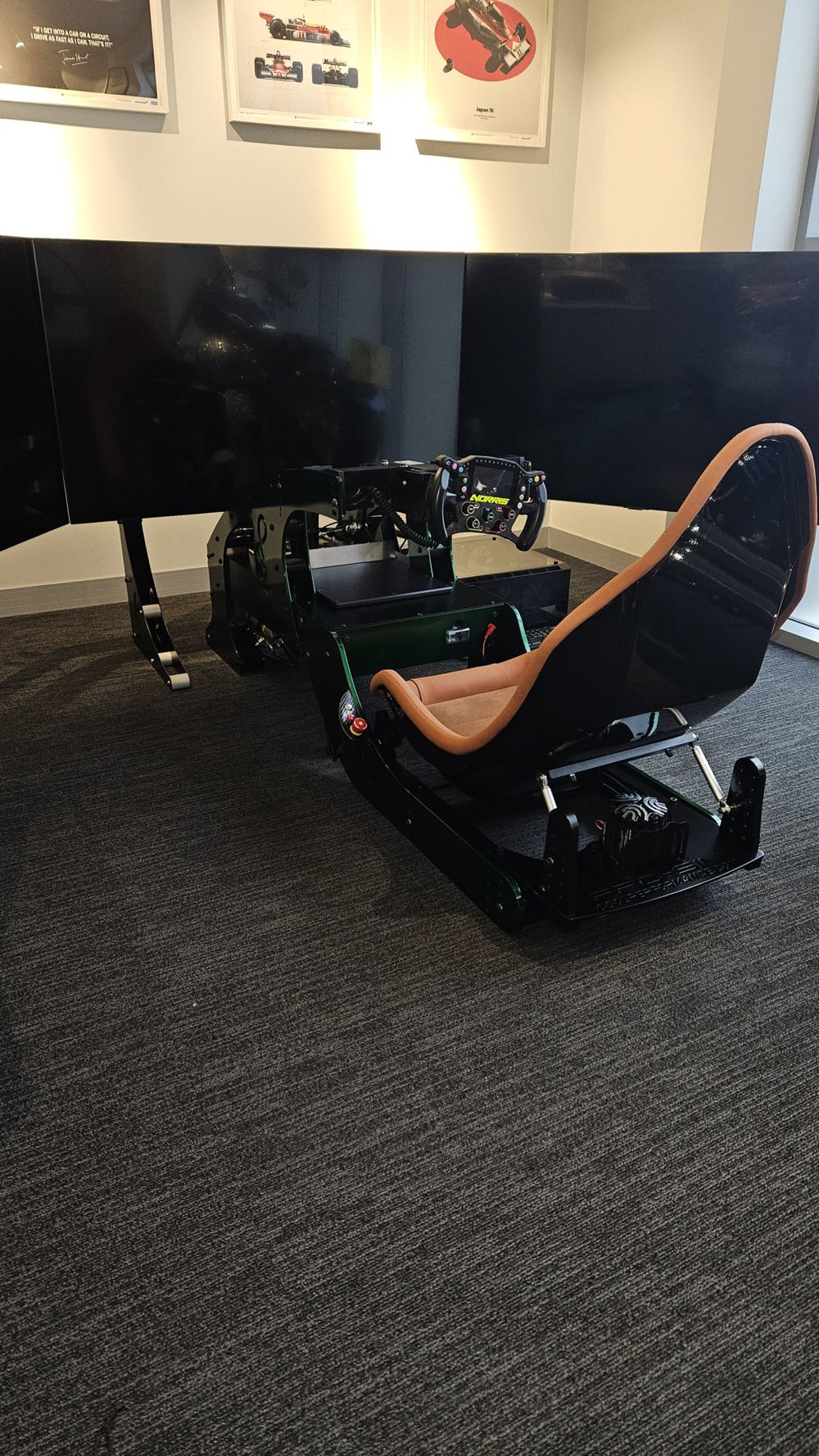 Racing green GT simulator with tan seat in the Tom Hartley Jnr showroom