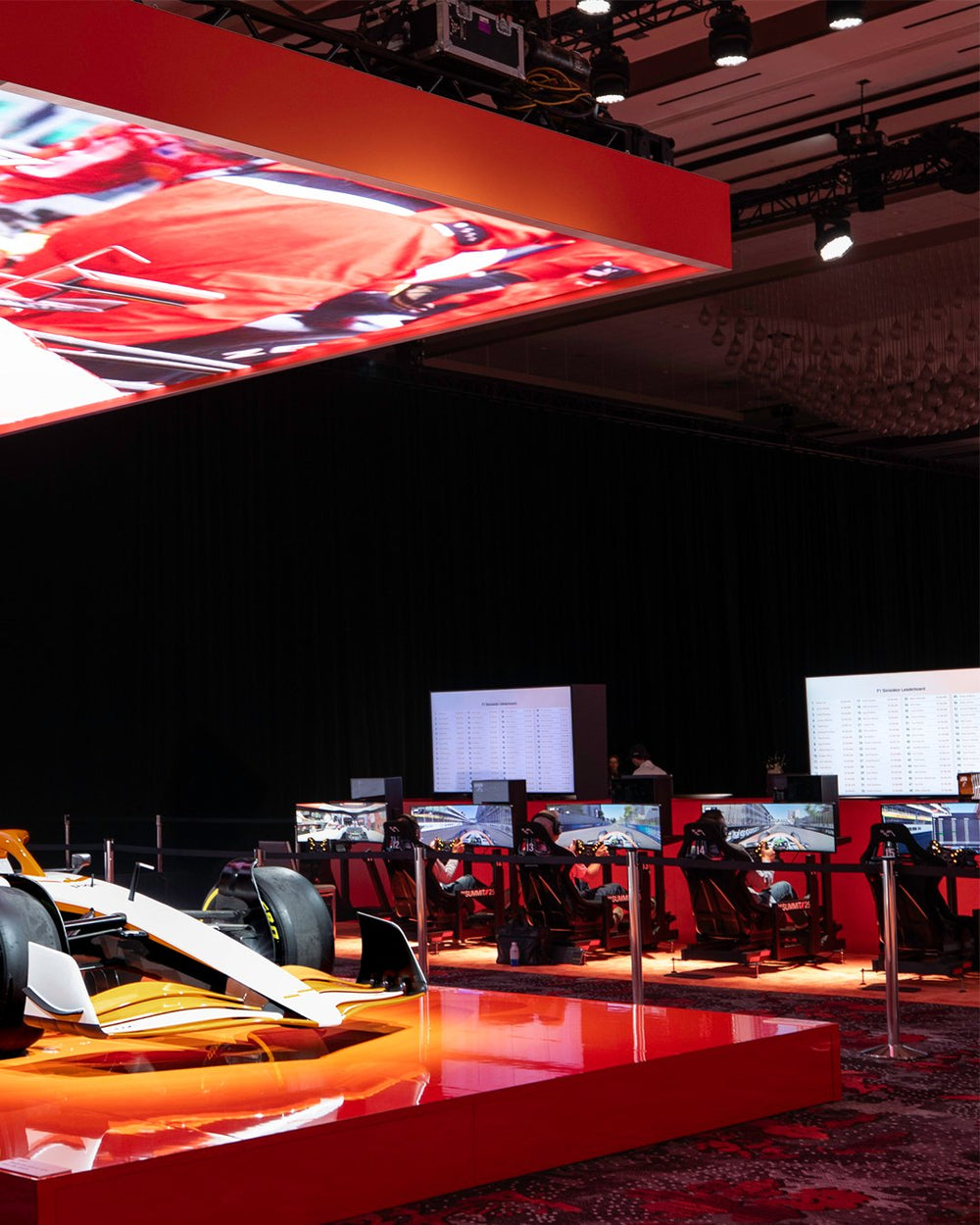 Row of hired racing simulators with leaderboards at a corporate event