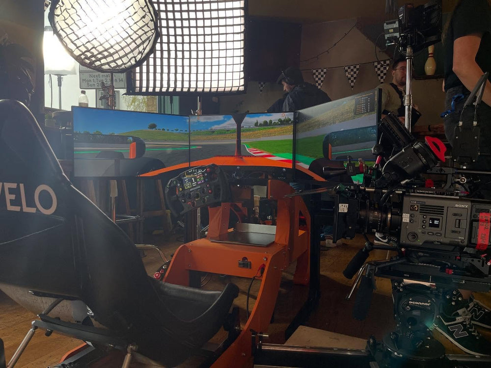 Papaya orange McLaren themed Formula simulator on a VELO promo shoot, London, UK