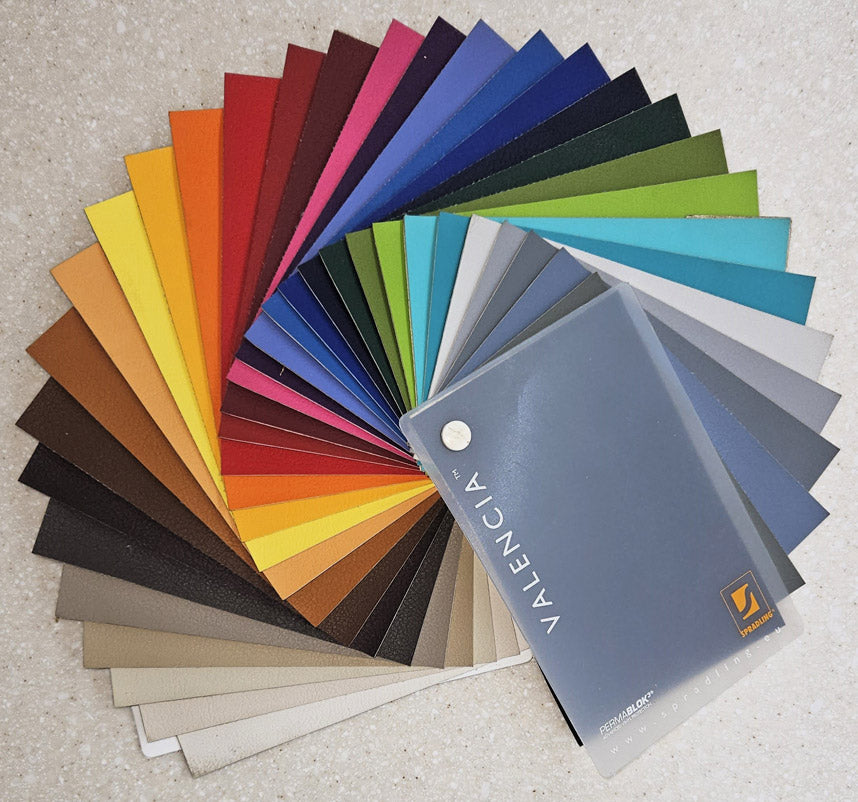 Colour swatch book with a wide range of colours on a neutral background