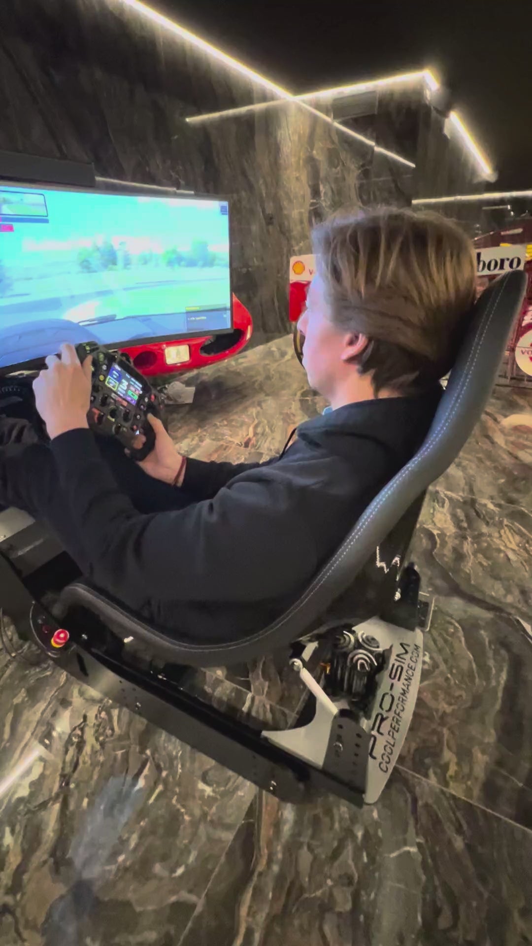 Load video: Cool Performance Formula Pro simulator amongst luxury car collection